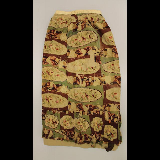 Floor length skirt with a light beige floral pattern on maroon and pale green background.