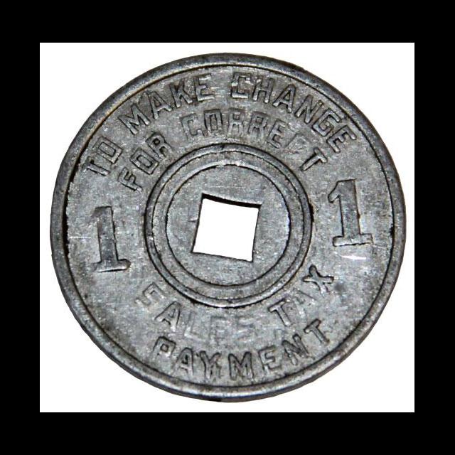 A color photograph of a metal coin used at a plantation store. The center of the coin has a square cutout. On the left and right sides are the values, in this instance "1." The top and bottom read, "To Make Change For Correct Sales Tax Payment."